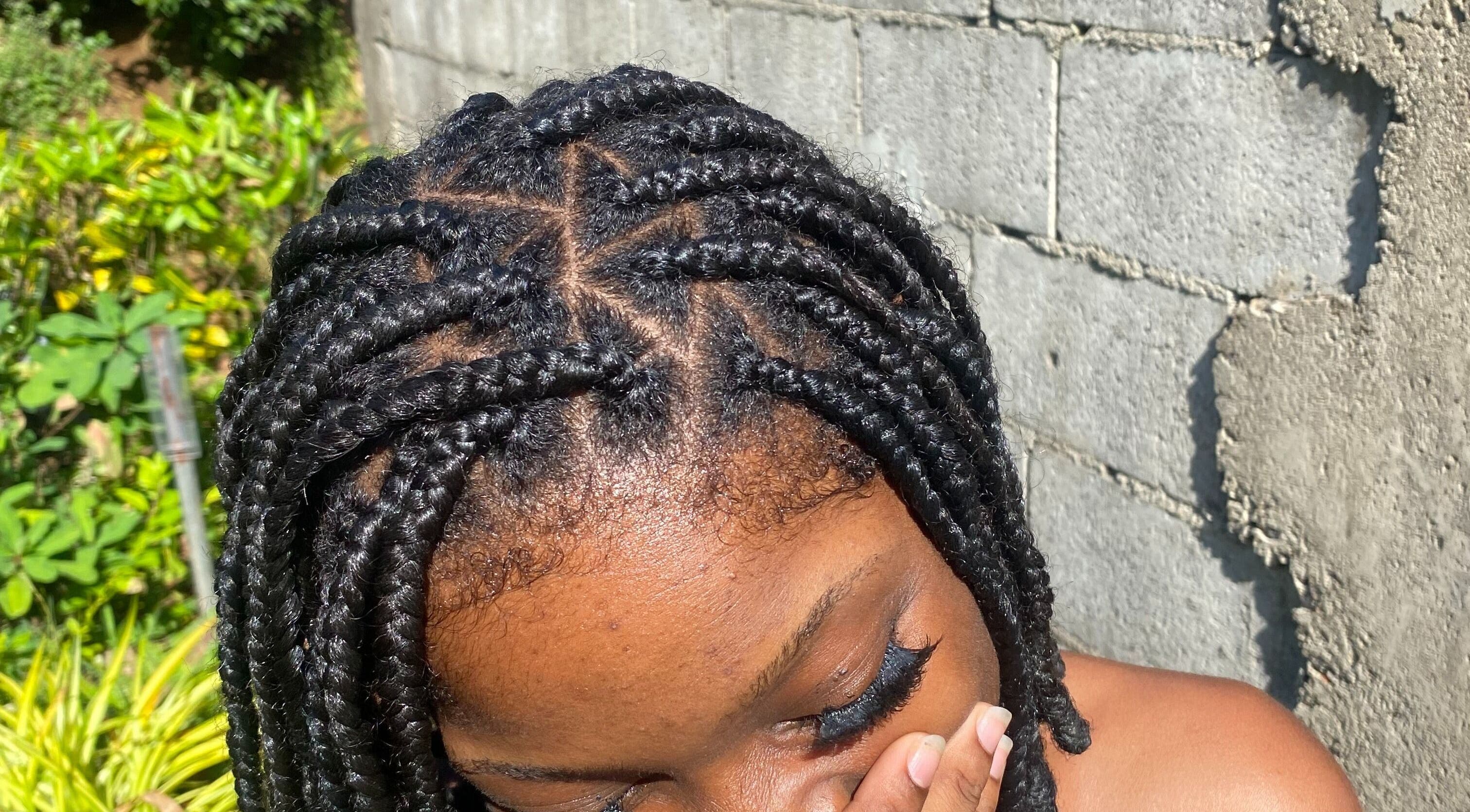 Intricate braids styled at Lash Up, Marigot, Saint Andrew Parish, DM showcasing natural beauty.