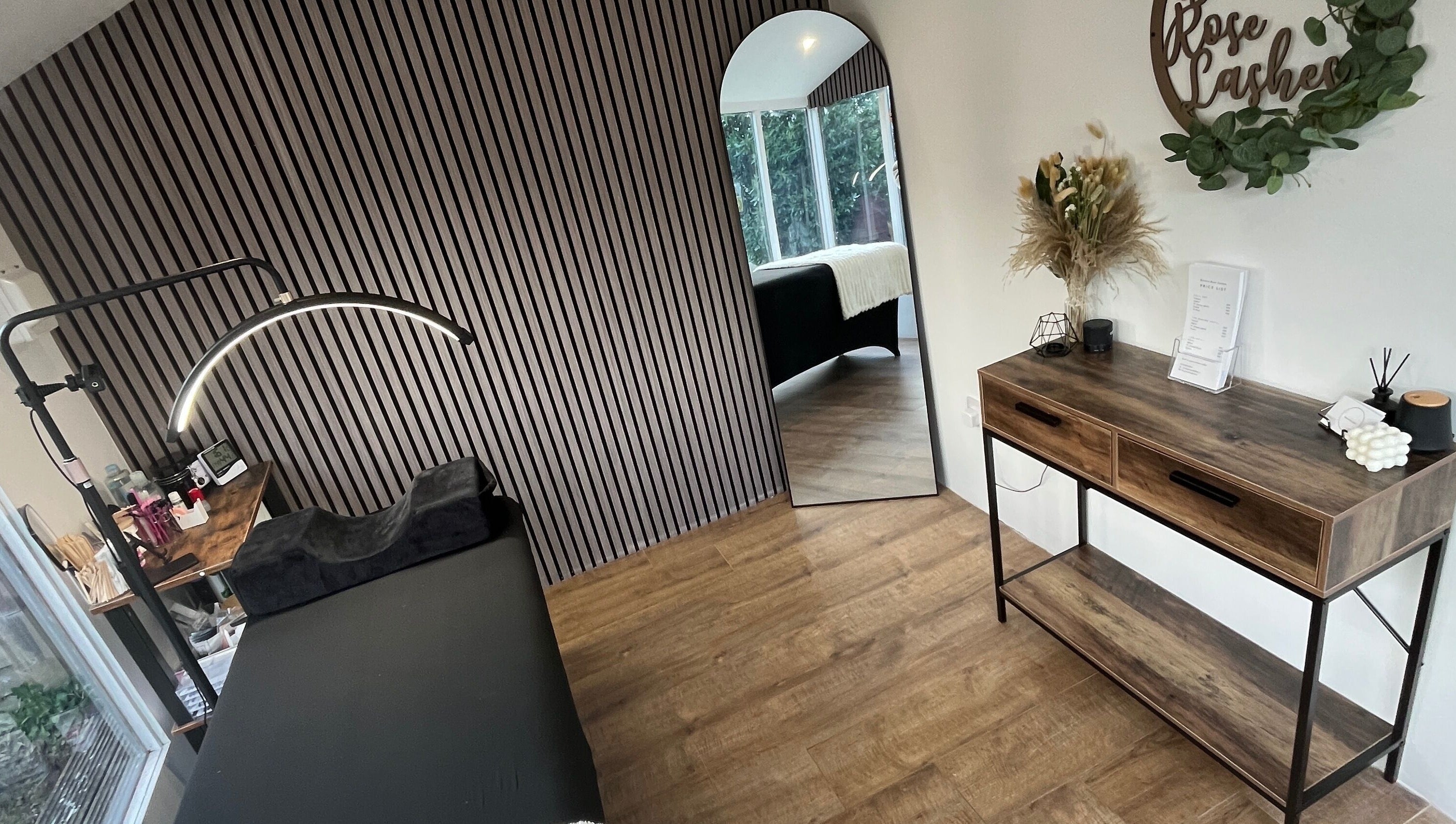 Chic interior at Bianca Rose Lashes, Saint Blazey, England, GB, featuring stylish decor and treatment table.