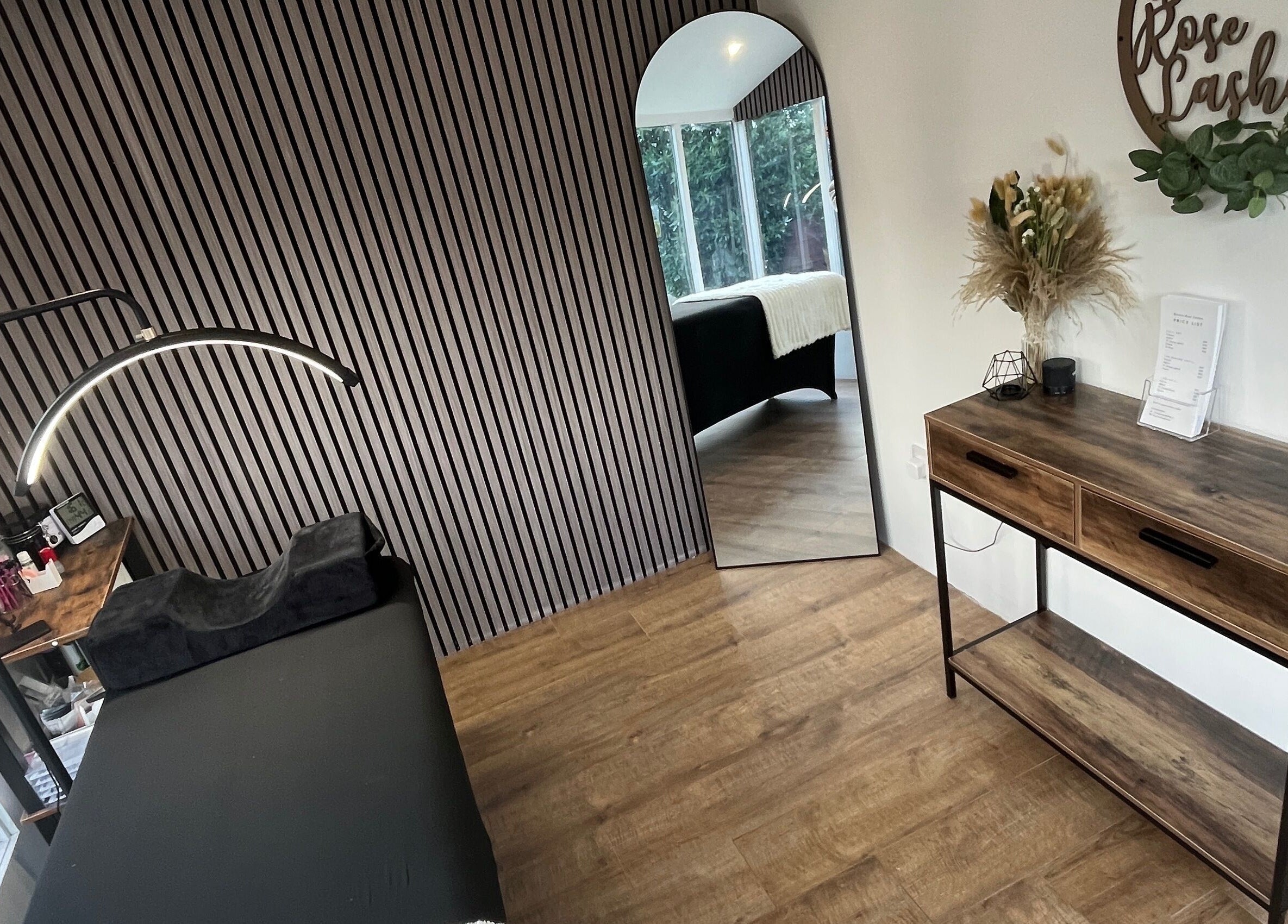 Chic interior at Bianca Rose Lashes, Saint Blazey, England, GB, featuring stylish decor and treatment table.