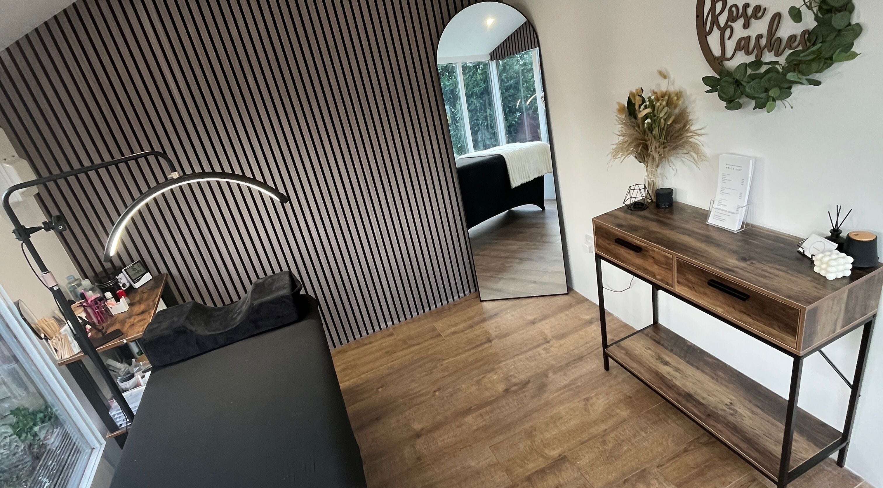 Chic interior at Bianca Rose Lashes, Saint Blazey, England, GB, featuring stylish decor and treatment table.