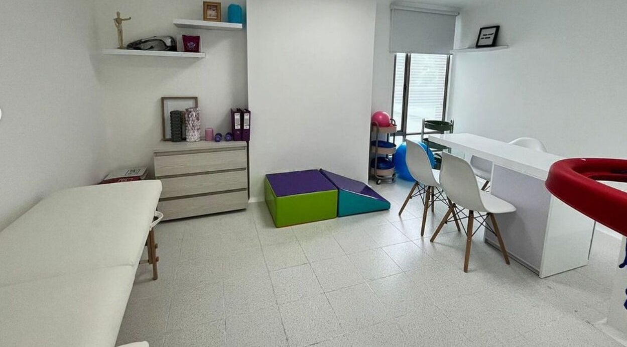 Sala de terapias en Fono-Care Bogotá, Bogotá, CO con muebles modernos y tonos relajantes.