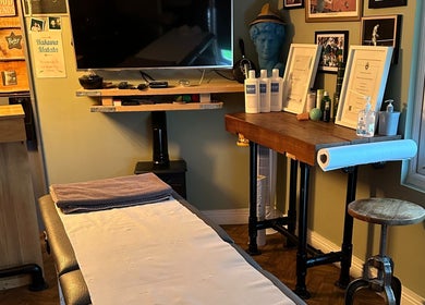 Cozy massage room at BTH Sports Massage, Heanor, England, GB, with a massage table and calming decor.