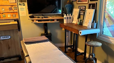 Cozy massage room at BTH Sports Massage, Heanor, England, GB, with a massage table and calming decor.