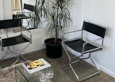 Sophisticated seating area at yourSPAce, Christchurch, Canterbury Region, NZ with sleek chairs and mirrored decor.