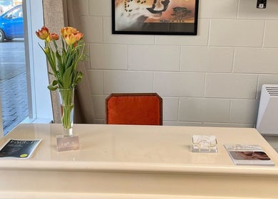 Cozy reception at yourSPAce in Christchurch, Canterbury Region, NZ with elegant flowers and brochures.