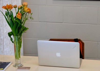 Elegant desk at yourSPAce, Christchurch, Canterbury Region, NZ with fresh flowers and laptop.