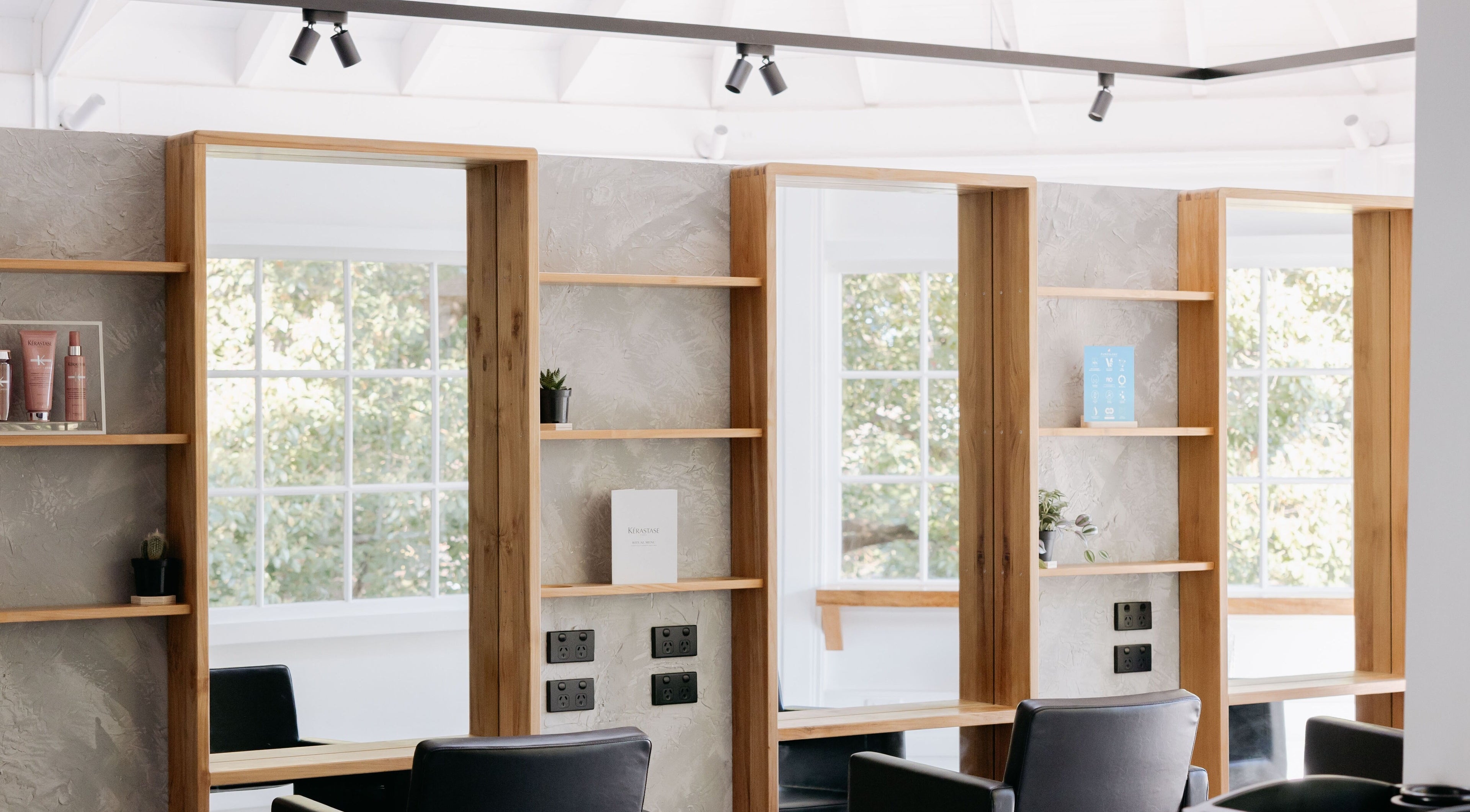 Modern salon interior at Studio 8 Hair - Mosman with stylish wooden mirrors in Mosman, New South Wales, AU.