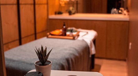 Relaxing treatment room at Polished Spa, Sharjah, AE, with calming decor and ambient lighting.