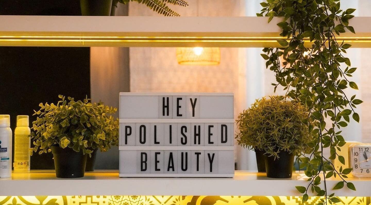 Polished Spa in Sharjah, AE: inviting display with plants and 'Hey Polished Beauty' sign.