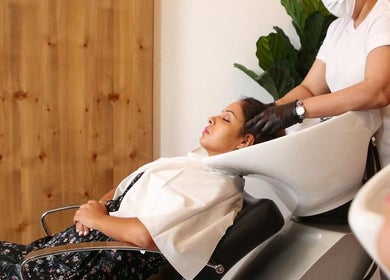 Client enjoys a hair wash at Polished Spa, Sharjah, AE for ultimate relaxation and care.