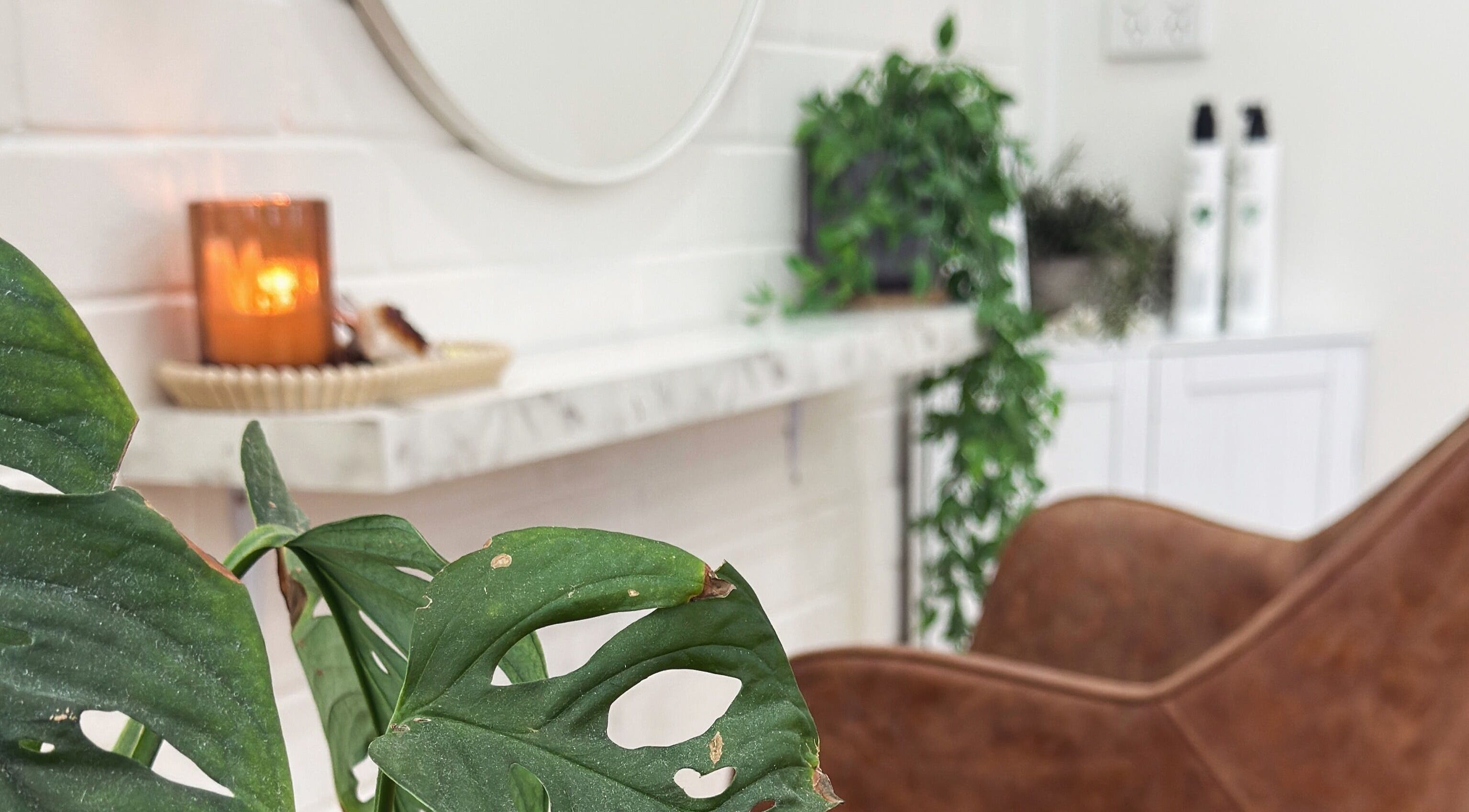 Calming decor at HAIR. by Shan in Mandurah, Western Australia, AU with plants and warm candlelit ambiance.