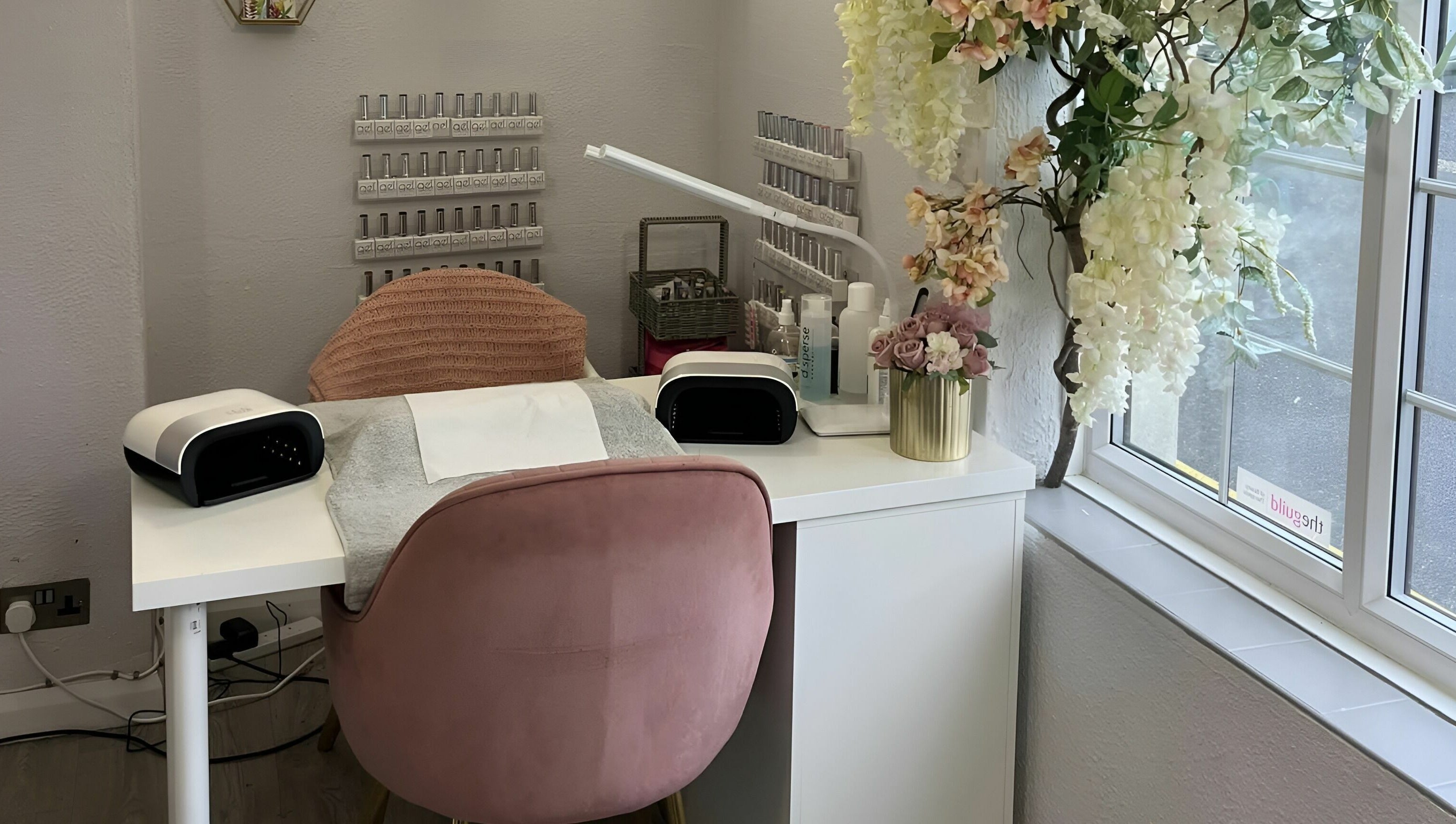 Cozy nail station at Seaside Retreat in Peel, Peel, IM with elegant decor and a plush pink chair.