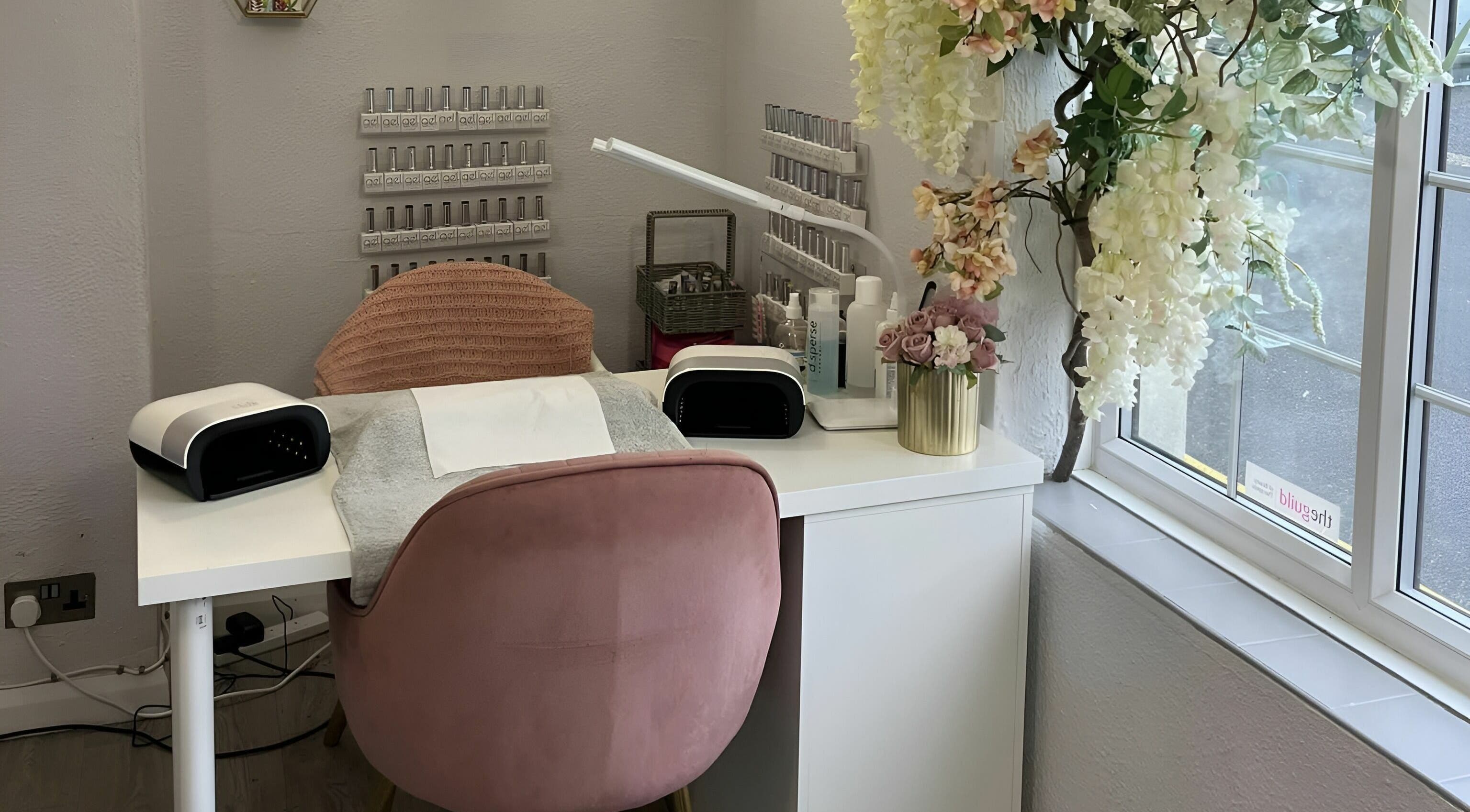 Cozy nail station at Seaside Retreat in Peel, Peel, IM with elegant decor and a plush pink chair.