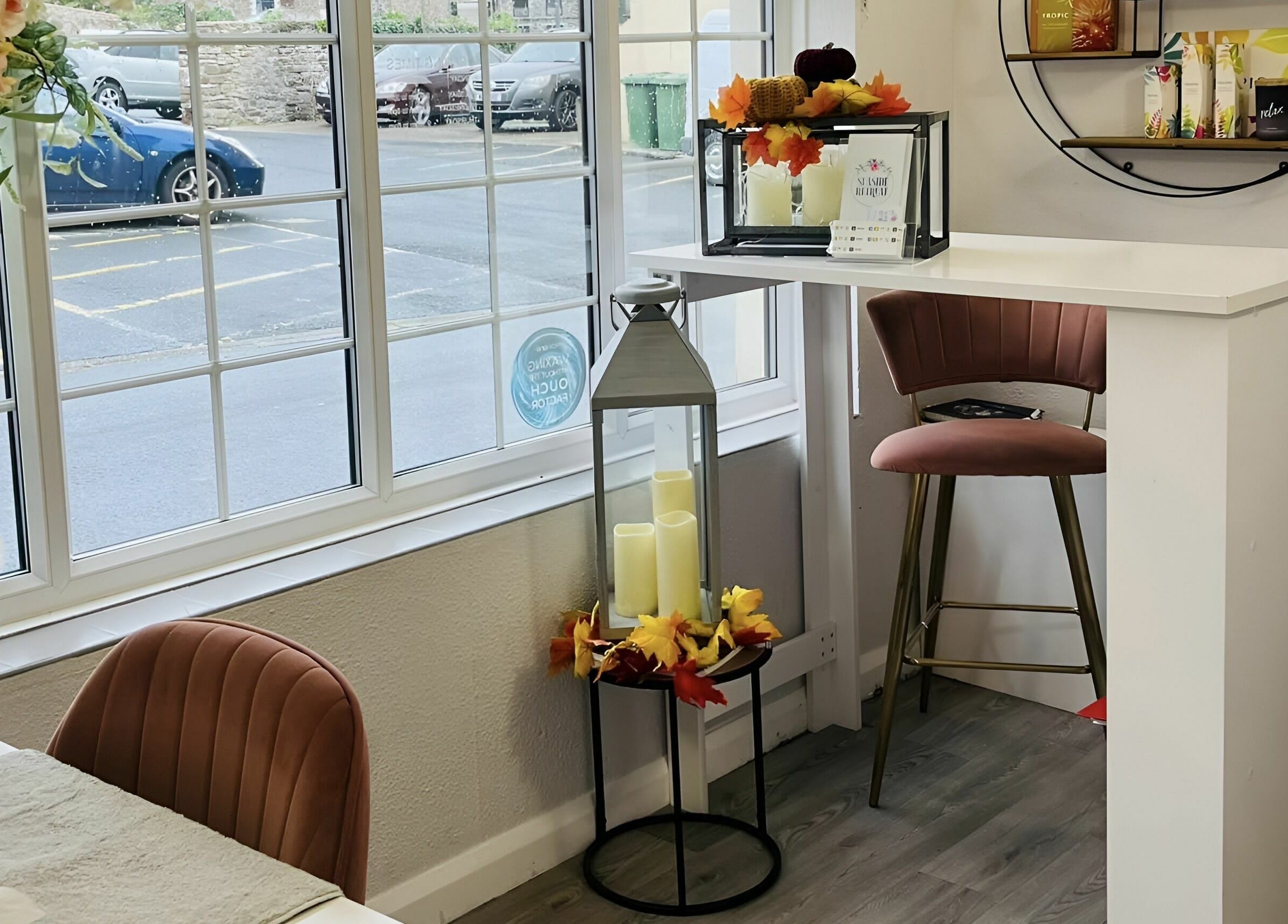 Seaside Retreat's cozy seating by the window in Peel, Peel, IM, adorned with candles and floral decor.