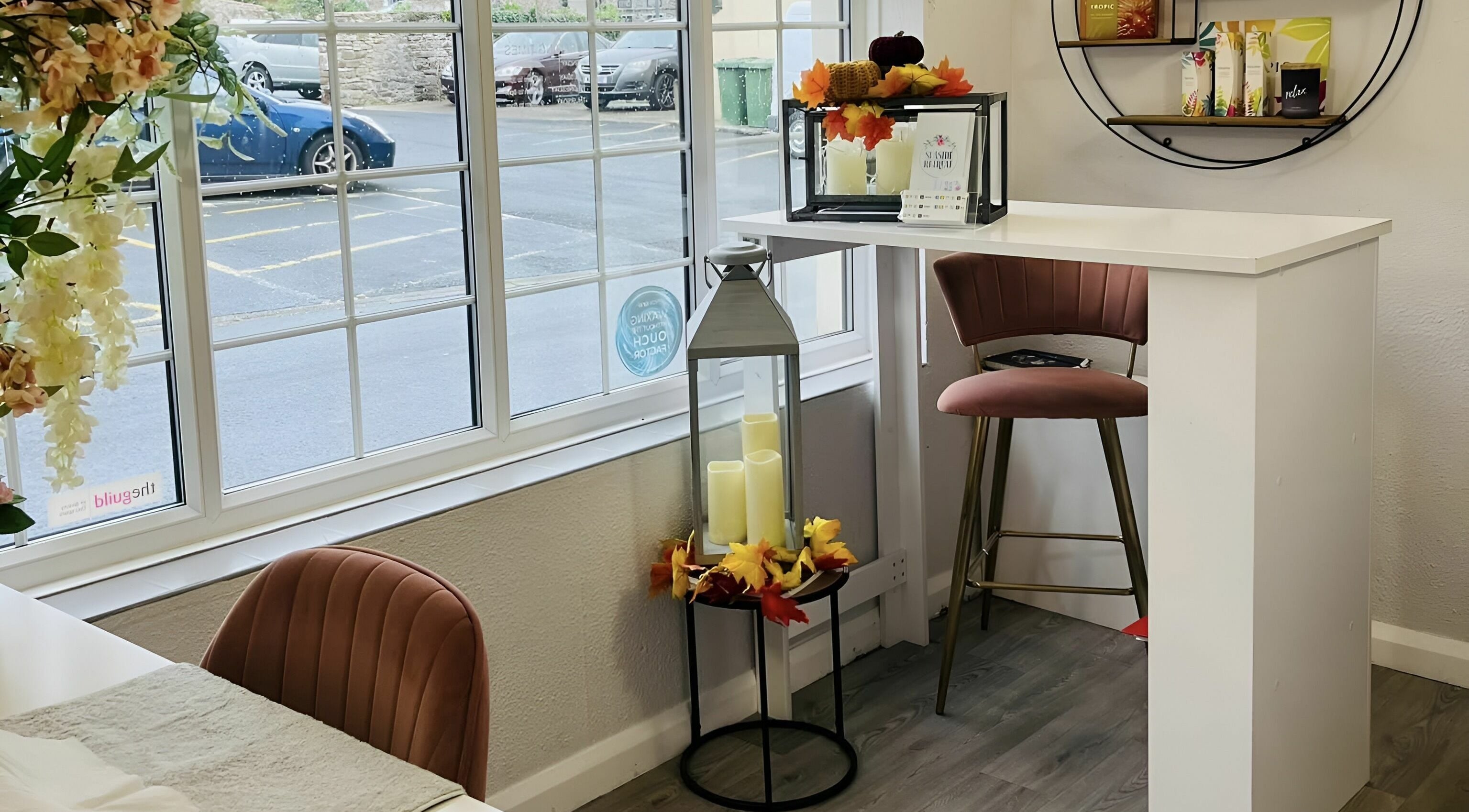 Seaside Retreat's cozy seating by the window in Peel, Peel, IM, adorned with candles and floral decor.