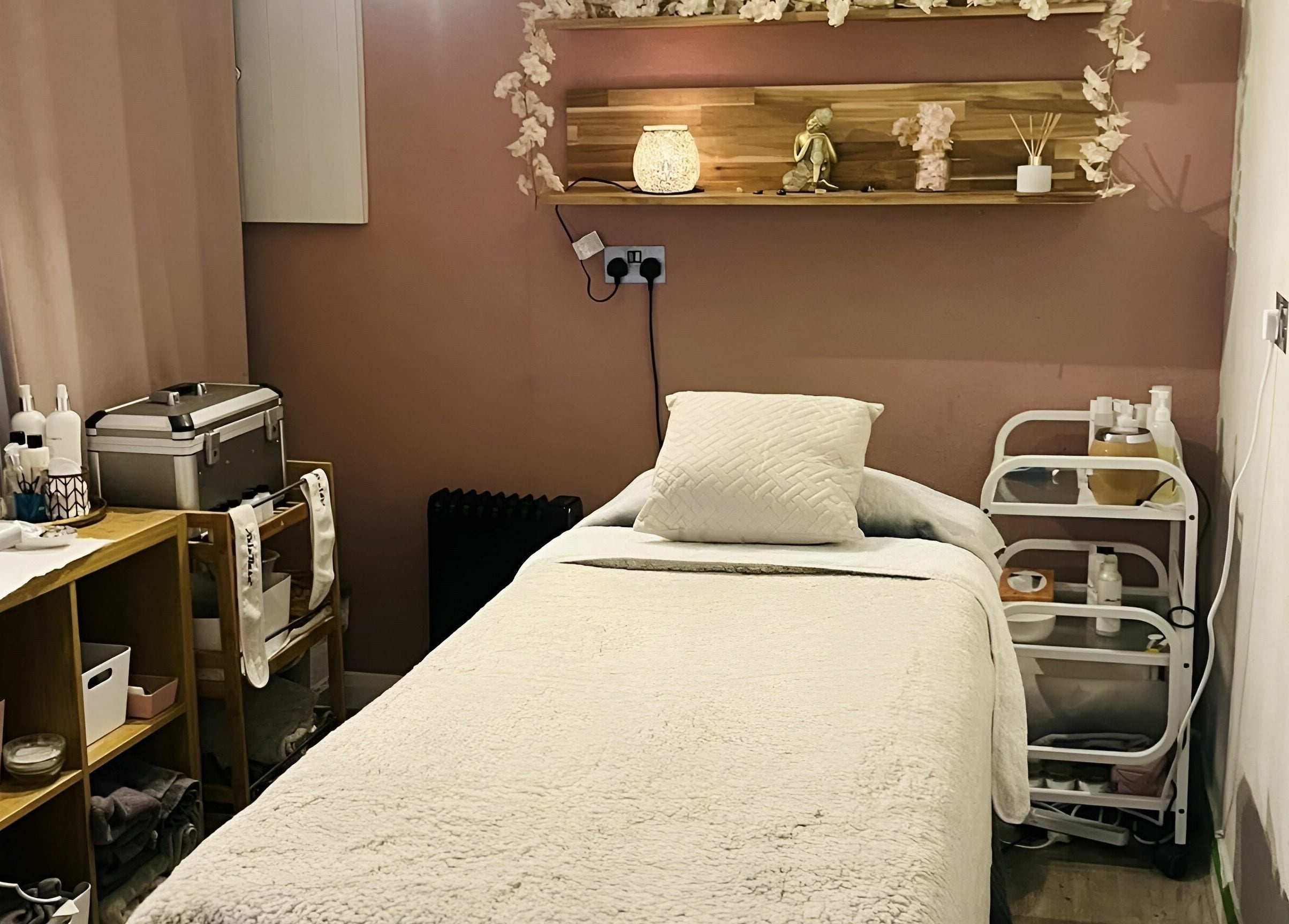 Calming massage room at Seaside Retreat, Peel, Peel, IM. Cozy setup with soft lighting and serene decor.