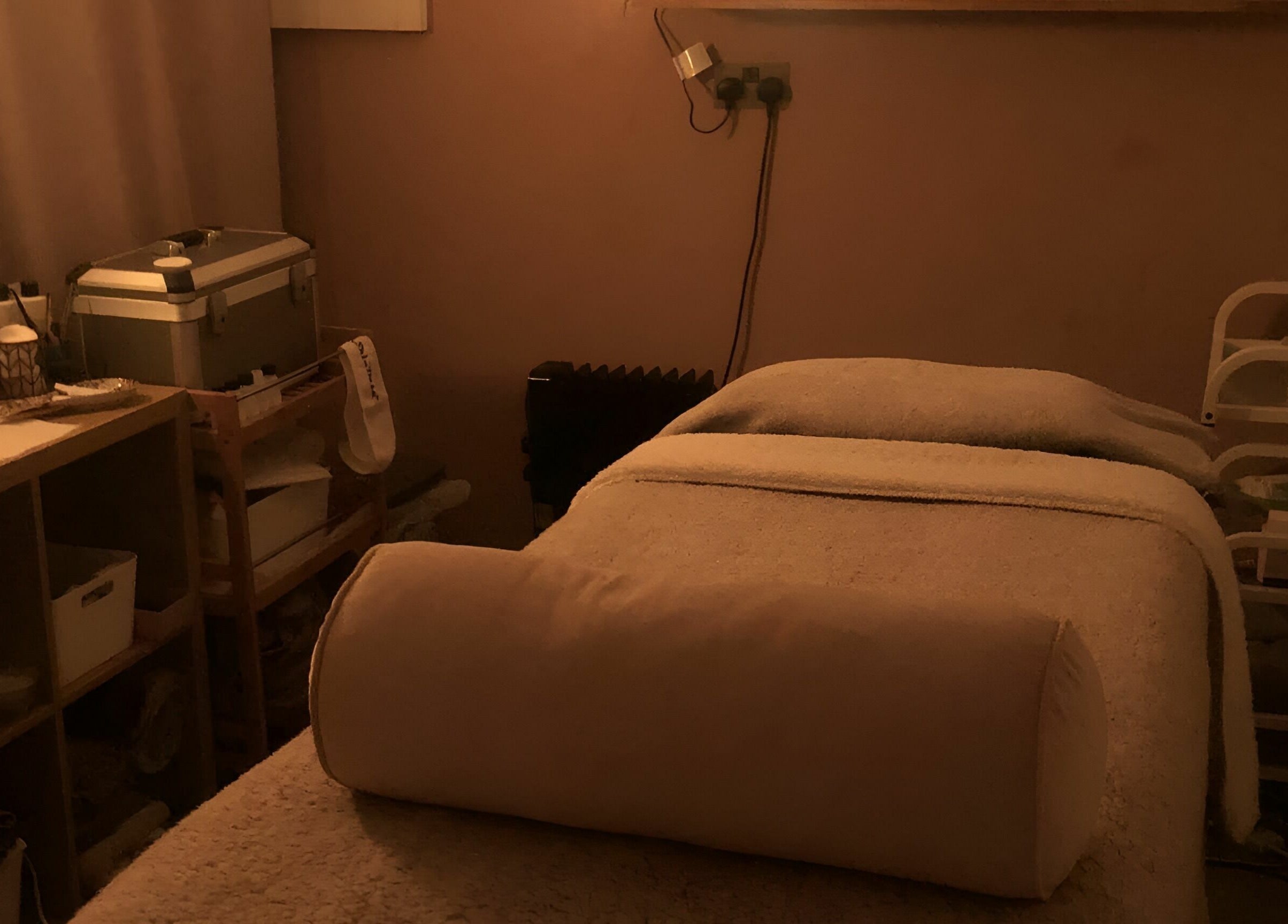 Relaxing spa room at Seaside Retreat, Peel, Peel, IM, featuring a cozy treatment bed and ambient lighting.