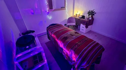 Cozy massage room with ambient lighting at The Massage Space, Winchester, England, GB, featuring a comfortable table.