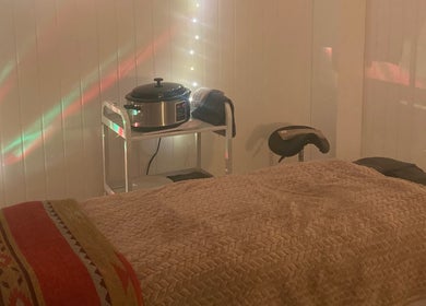 Peaceful massage room at The Massage Space, Winchester, England, GB with soft lighting and comfortable bed.