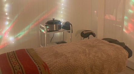 Peaceful massage room at The Massage Space, Winchester, England, GB with soft lighting and comfortable bed.