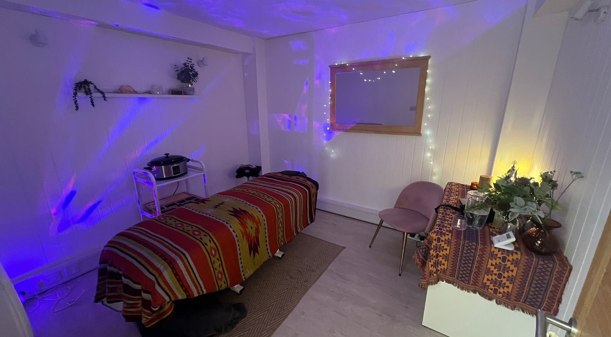 Relaxing massage room at The Massage Space in Winchester, England, GB with ambient lighting and decor.