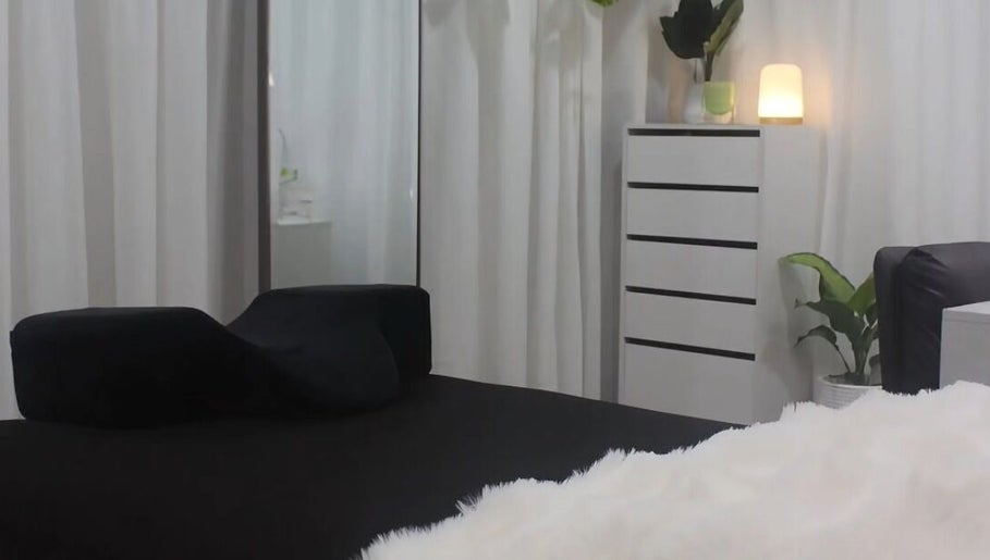 Elegant spa bed setup at Eve Beauty Room, Tuggerah, New South Wales, AU. Bright, serene atmosphere with lush plants.