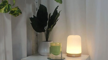 Relaxing ambiance at Eve Studio, Tuggerah, New South Wales, AU, featuring a soft-lit lamp and greenery.