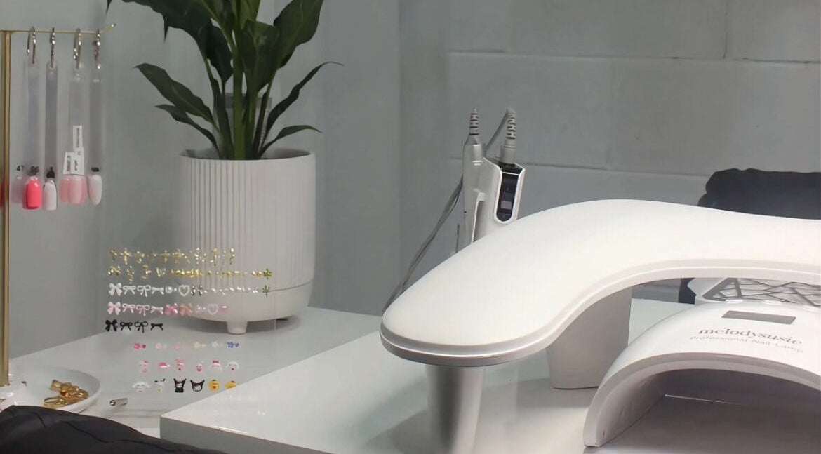 Eve Studio's chic nail station in Tuggerah, New South Wales, AU with nail art supplies and plant decor.