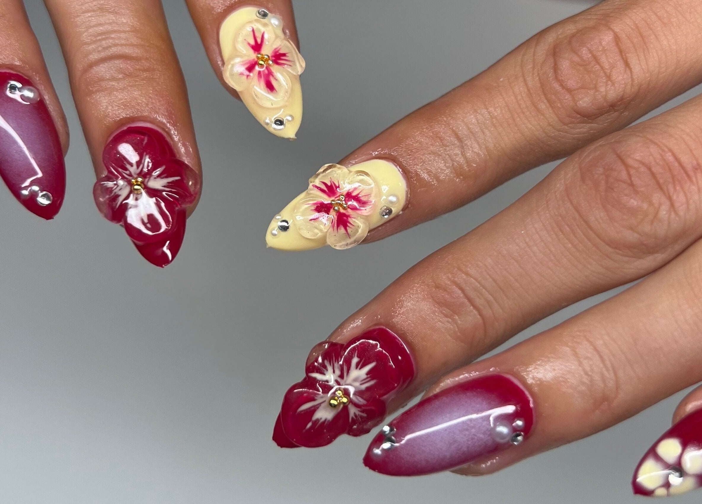 Intricate floral nail art at Eve Studio, Tuggerah, New South Wales, AU showcasing maroon and ivory designs.