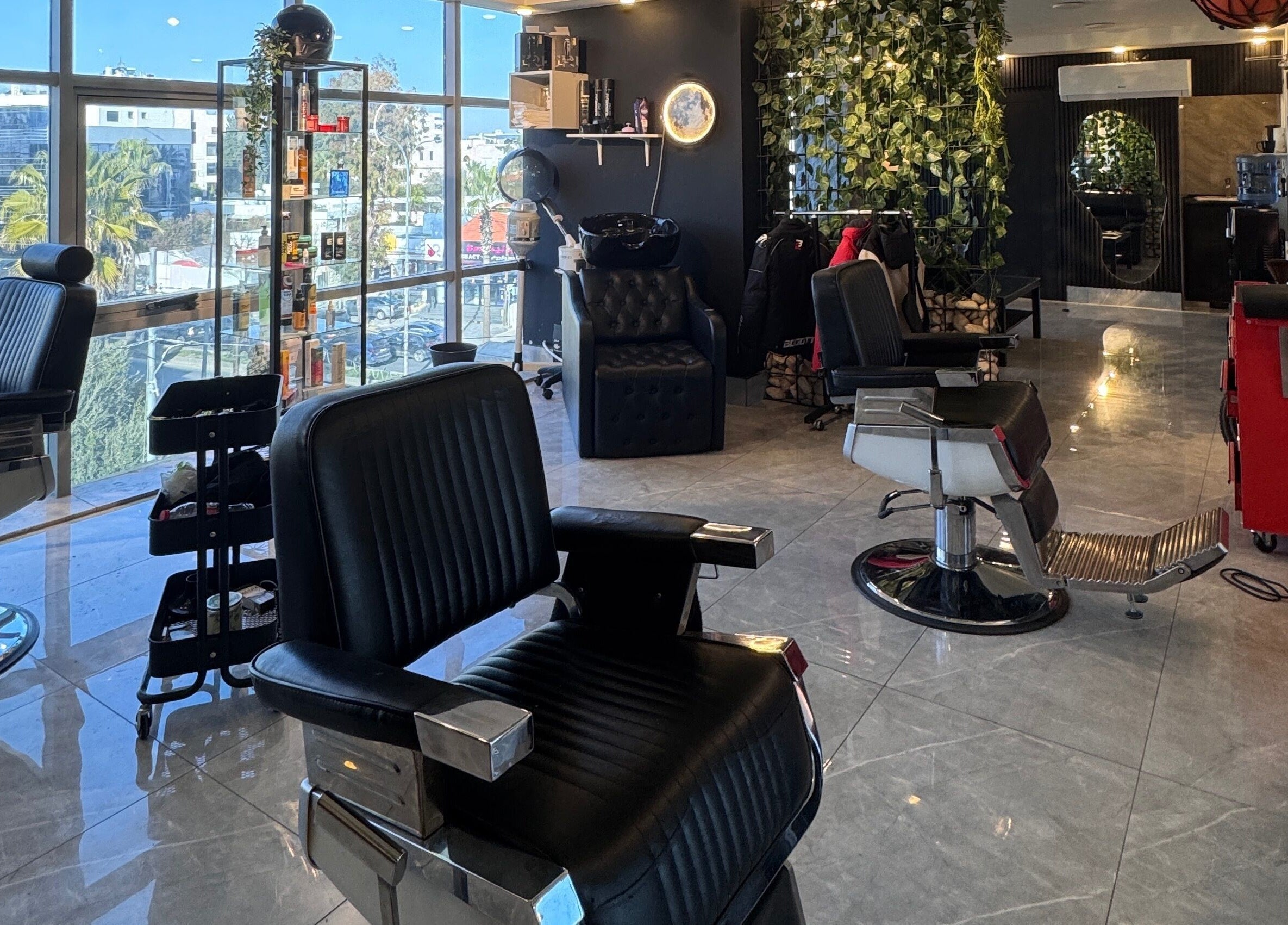 Modern barbershop at The Dala, Amman, Amman Governorate, JO, with stylish chairs and sleek decor.
