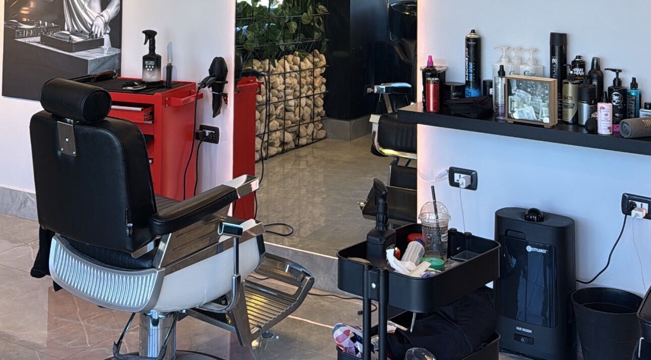 Modern salon interior at The Dala, Amman, Amman Governorate, JO featuring stylish barber chair and grooming tools.