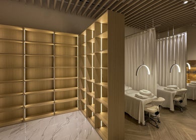 Elegant spa interior at The Usual Lash, Darien, Connecticut, US with warm lighting and massage tables.