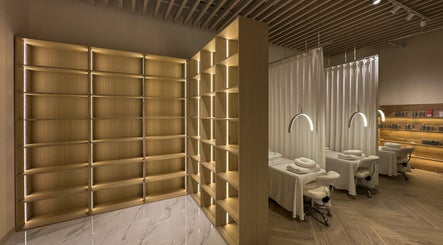 Elegant spa interior at The Usual Lash, Darien, Connecticut, US with warm lighting and massage tables.