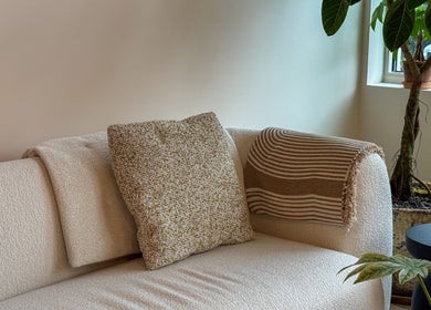 Inviting cozy seating area at The Usual Lash in Darien, Connecticut, US with a plush sofa and plant decor.