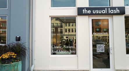Entrance of The Usual Lash, Darien, Connecticut, US with stylish signage and a flower pot.