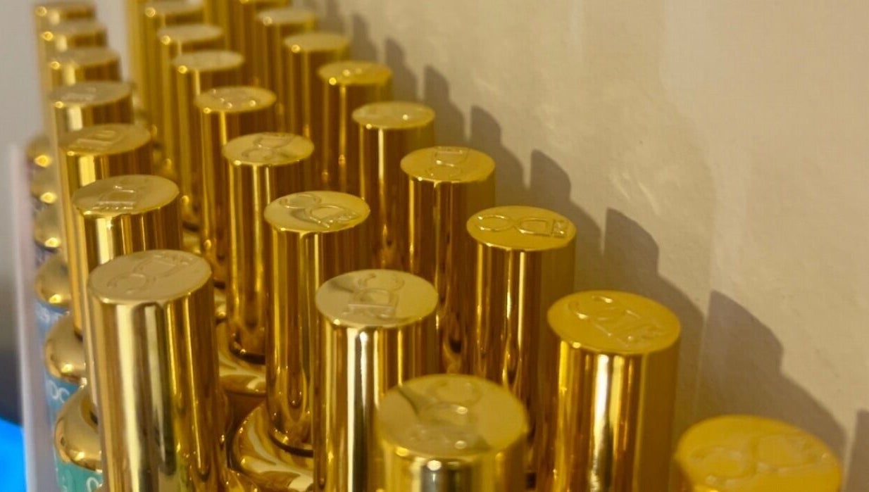 Elegant gold bottles on display at Pretty Please by Tay in Brockville, Ontario, CA.