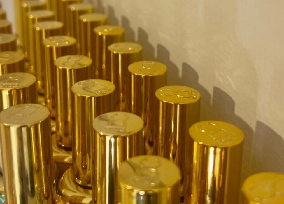 Elegant gold bottles on display at Pretty Please by Tay in Brockville, Ontario, CA.