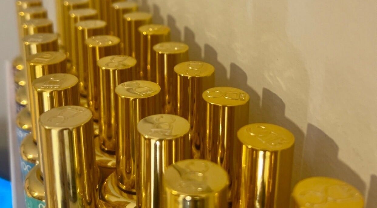 Elegant gold bottles on display at Pretty Please by Tay in Brockville, Ontario, CA.