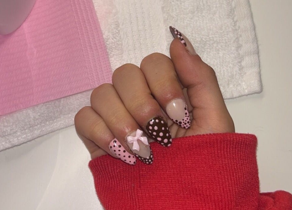 Elegant polka dot nail art at Pretty Please by Tay, Brockville, Ontario, CA. Unique design with pink and brown hues.