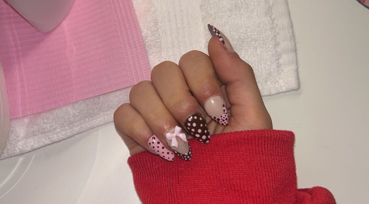 Elegant polka dot nail art at Pretty Please by Tay, Brockville, Ontario, CA. Unique design with pink and brown hues.