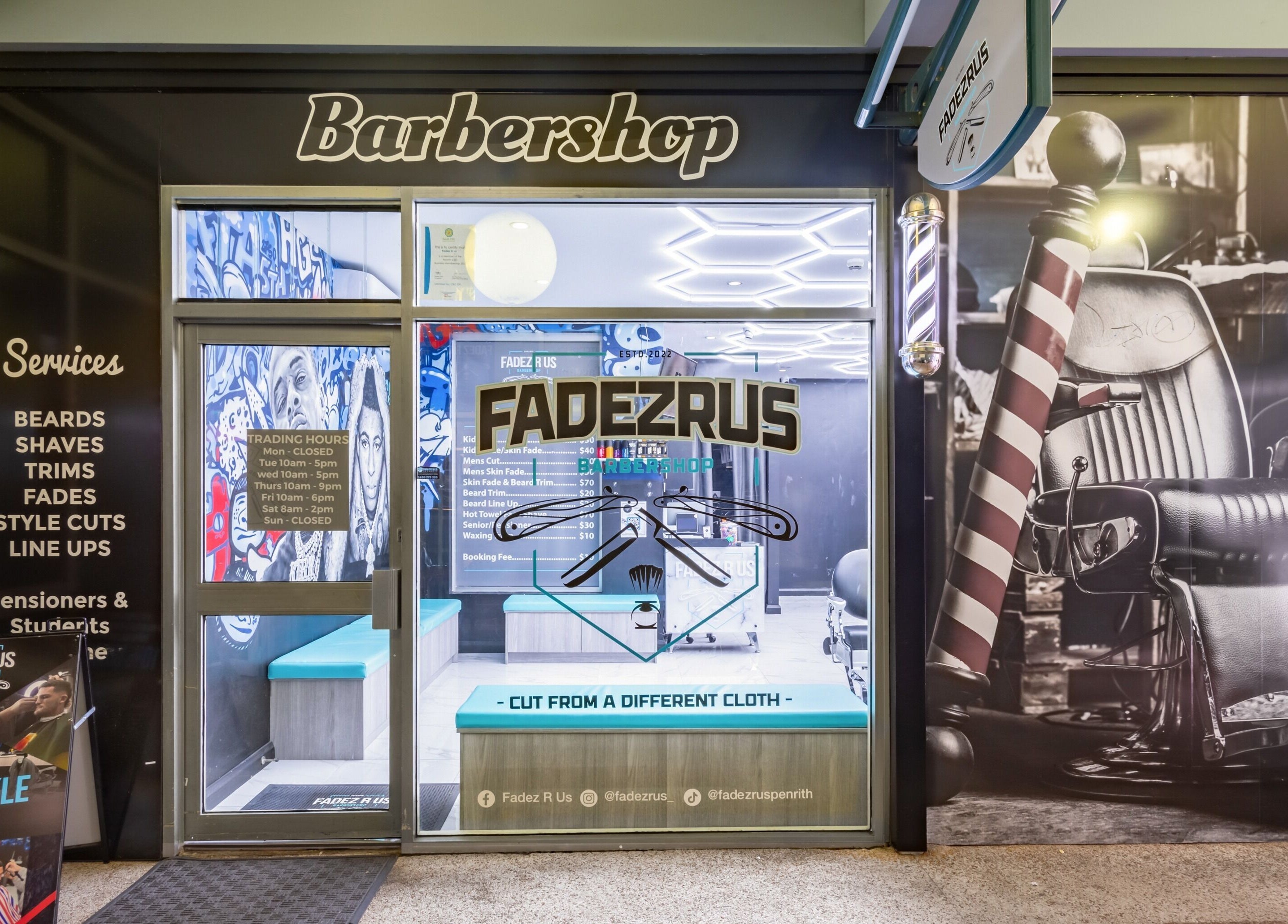 Front entrance of FADEZ R US barbershop in Penrith, NSW, AU showcasing barber chair and services list.