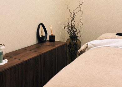 Cozy treatment room at Emma W Beauty at Muse Studio, Bristol, England, GB with soft linens and calming decor.