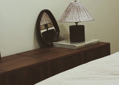 Elegant bedside decor at Emma W Beauty at Muse Studio, Bristol, England, GB featuring a lamp and mirror.