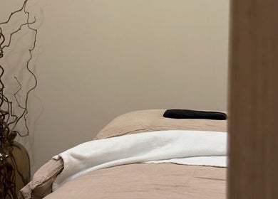 Cozy massage bed at Emma W Beauty at Muse Studio, Bristol, England, GB. Warm lighting and decor enhance the ambiance.