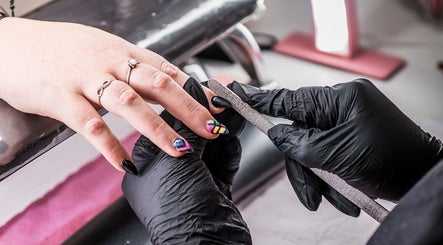 Nail technician filing vibrant nails at Yolanush Beauty Lounge, Kempton Park, Gauteng, ZA.