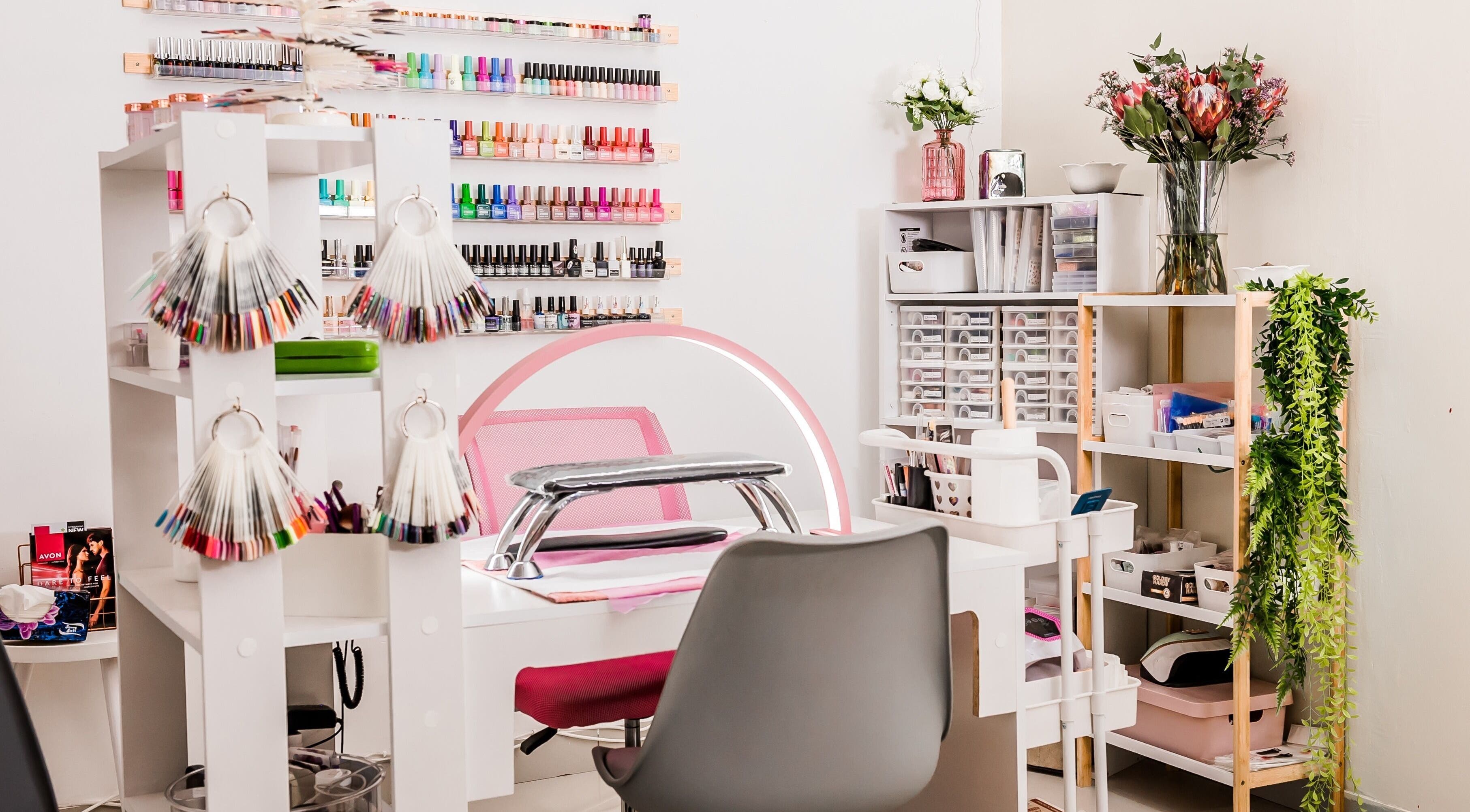 Bright nail salon station at Yolanush Beauty Lounge, Kempton Park, Gauteng, ZA with colorful polish displays.
