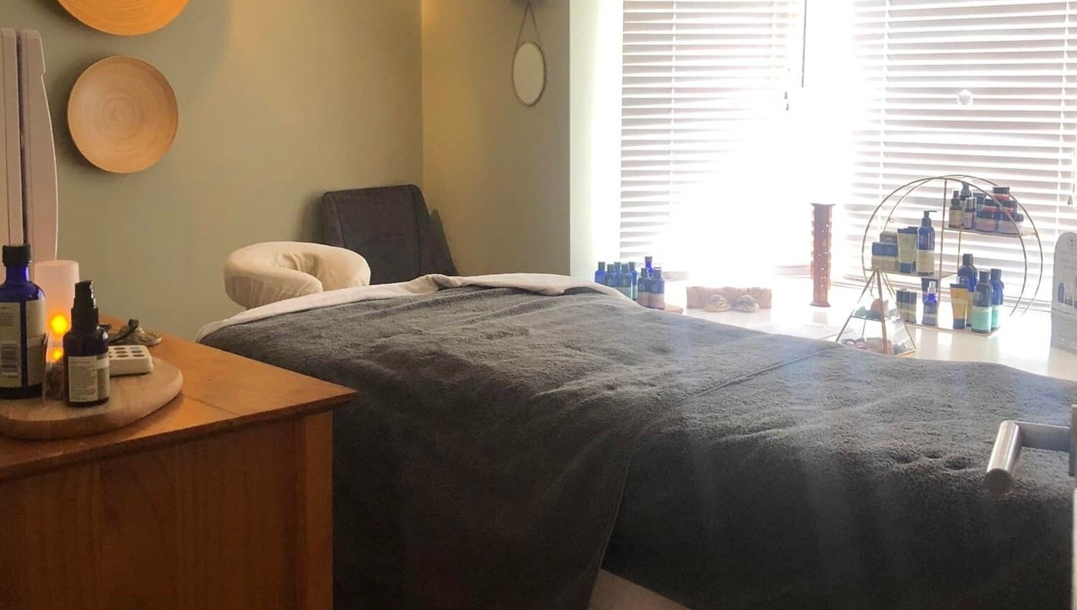 Tranquil massage room at Apple Lodge Therapies in Redditch, England, GB, featuring a cozy bed and essential oils.