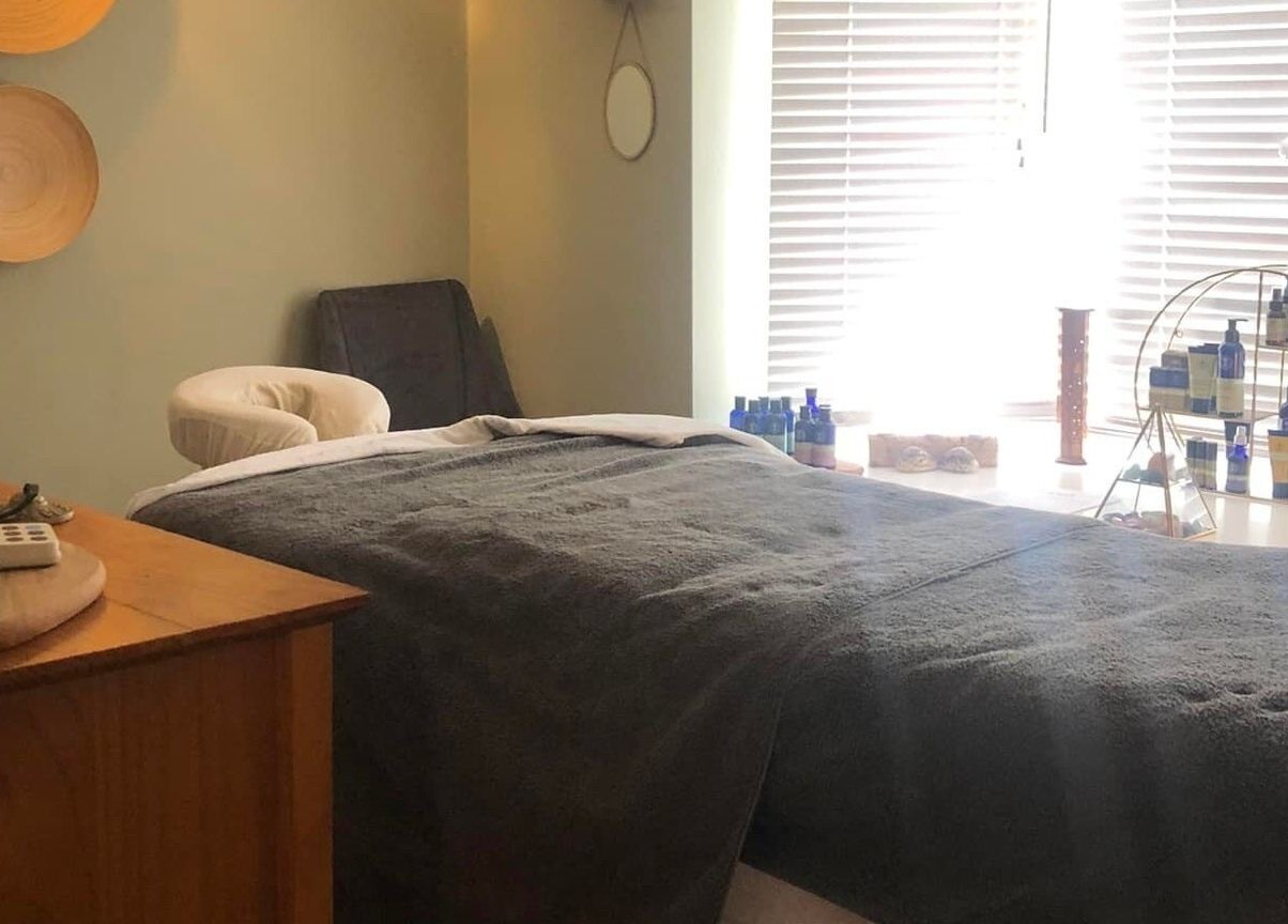 Tranquil massage room at Apple Lodge Therapies in Redditch, England, GB, featuring a cozy bed and essential oils.