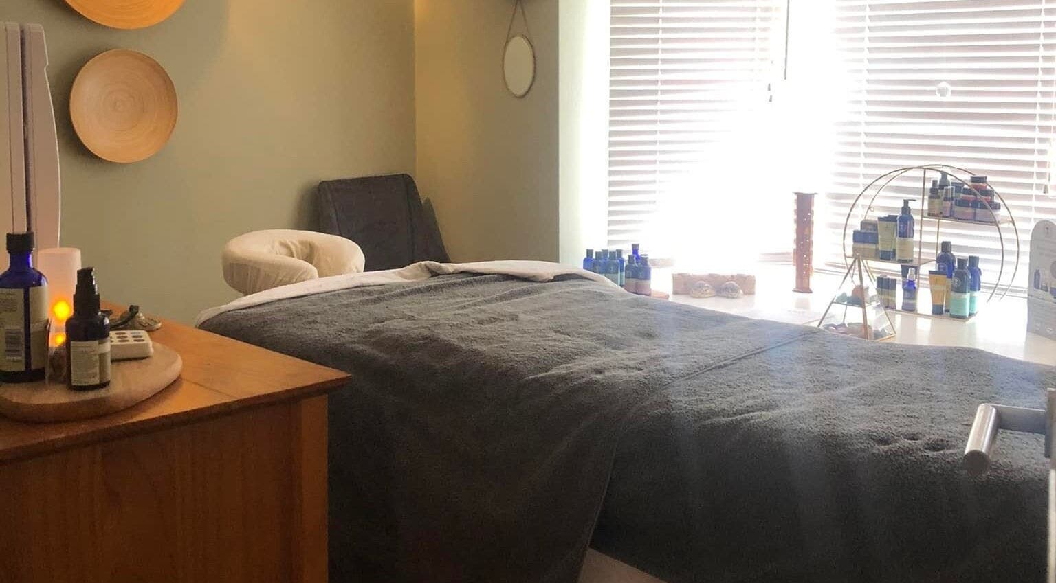 Tranquil massage room at Apple Lodge Therapies in Redditch, England, GB, featuring a cozy bed and essential oils.