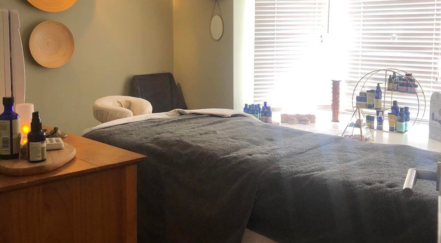 Tranquil massage room at Apple Lodge Therapies in Redditch, England, GB, featuring a cozy bed and essential oils.